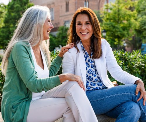 Beautiful senior women bonding outdoors in the city - Attractive cheerful mature female friends having fun, shopping and bonding, concepts about elderly lifestyle
